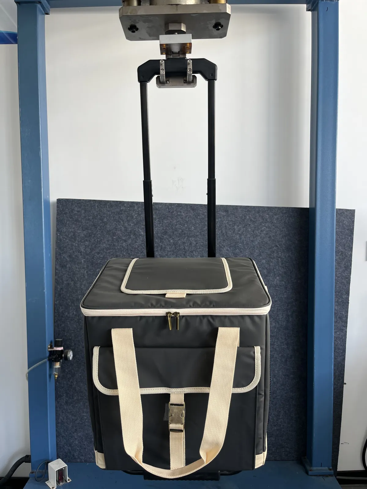 TrailCooler Pro cooler bag telescopic handle undergoing load testing in a lab rig